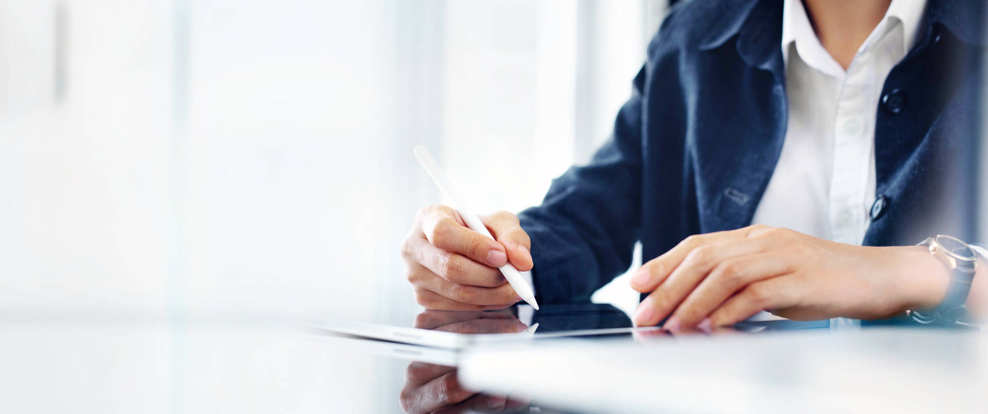 Cropped close-up of a team member using a stylus pen with tablet
