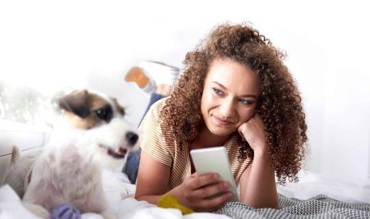 girl with dog on phone