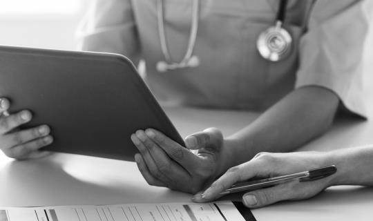 Business Solutions. Veterinarian reviewing MWI Animal Health Practice Management Technology Software