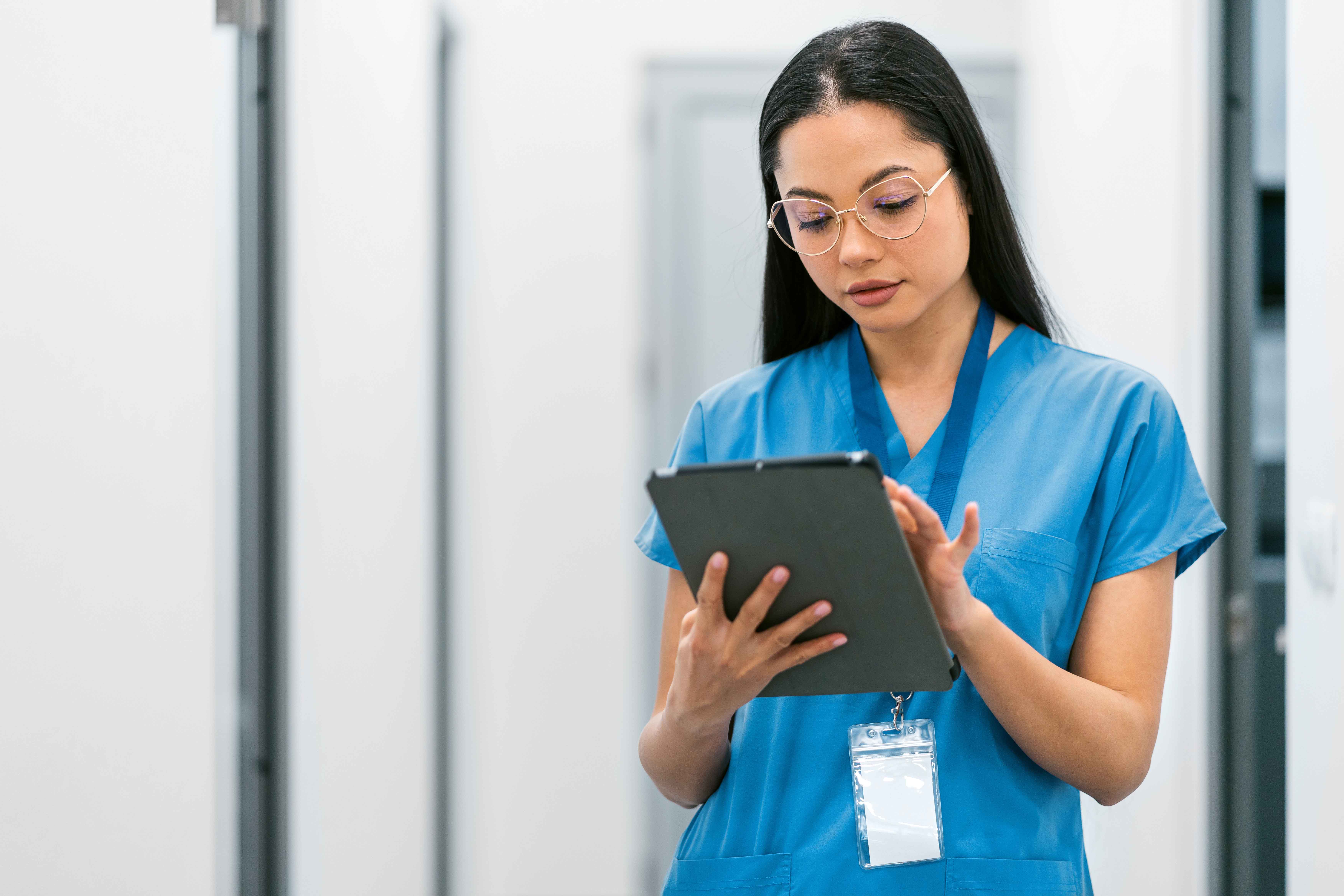 Vet tech checking some information on a tablet