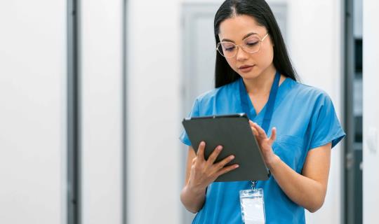 Vet tech checking some information on a tablet
